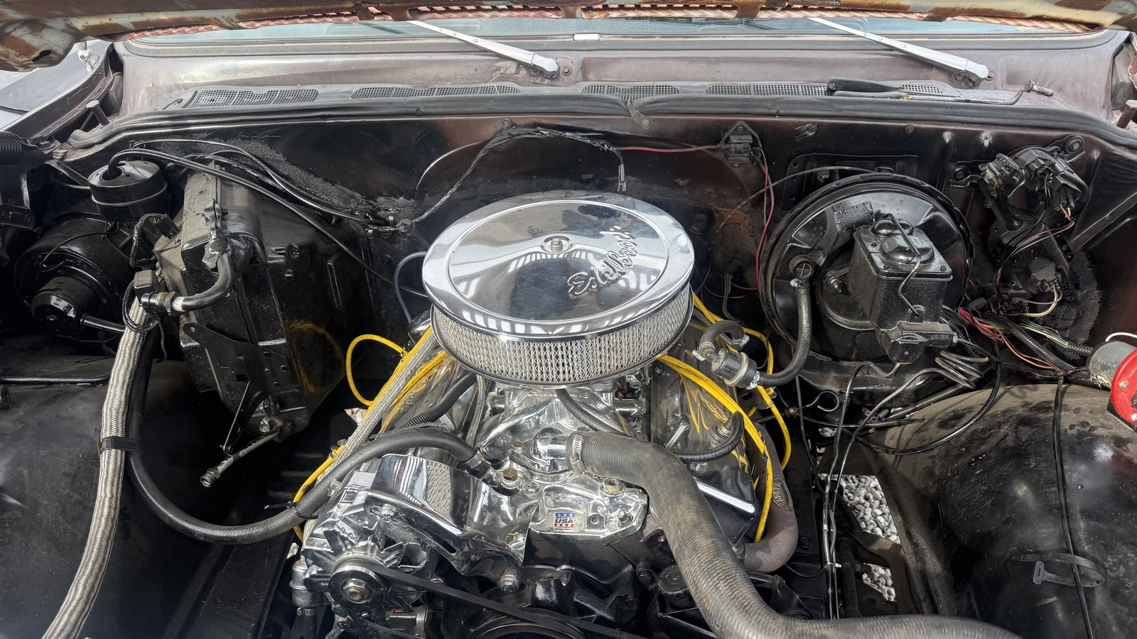Chrome dressed small block V8 with an Edelbrock air cleaner, installed in a classic pickup at Supercanic