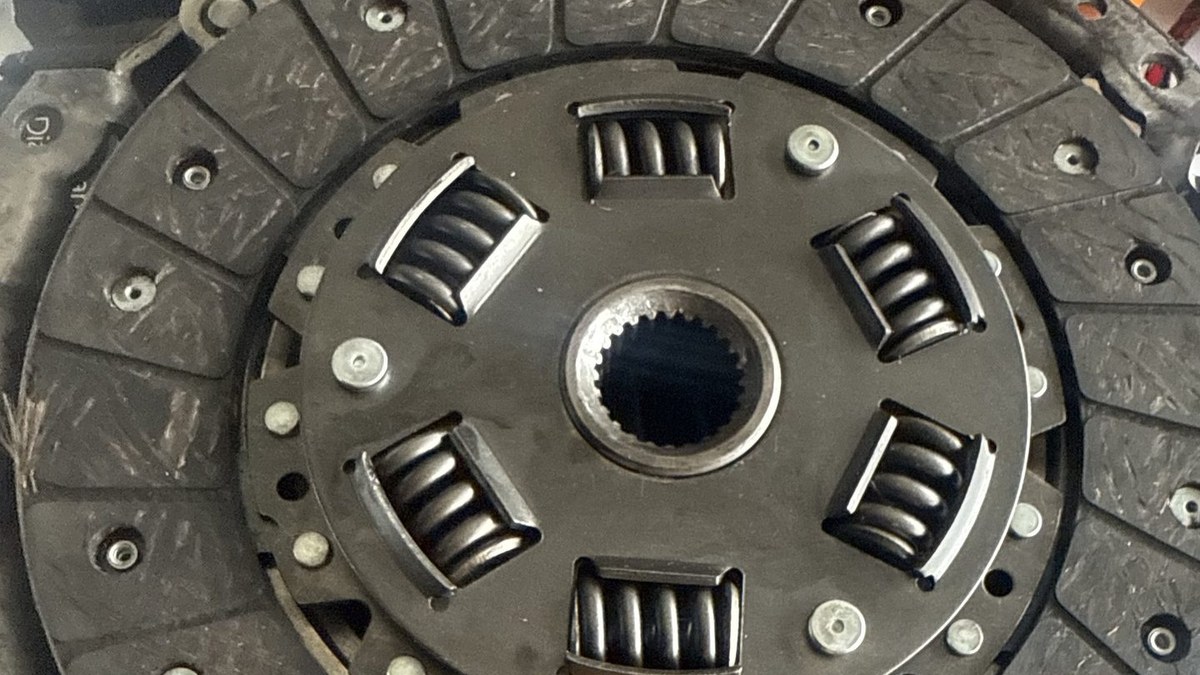 Clutch disc and pressure plate pulled from a manual transmission car