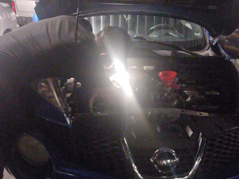 Nissan in the shop with the hood up