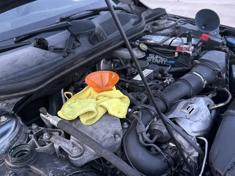 Engine bay with the hood up during a mobile repair