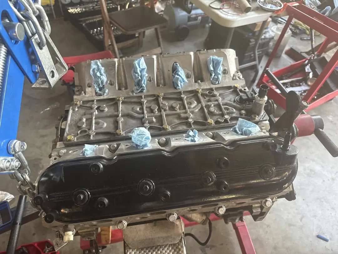 An LS V8 on a stand with the intake ports taped over and the valley exposed
