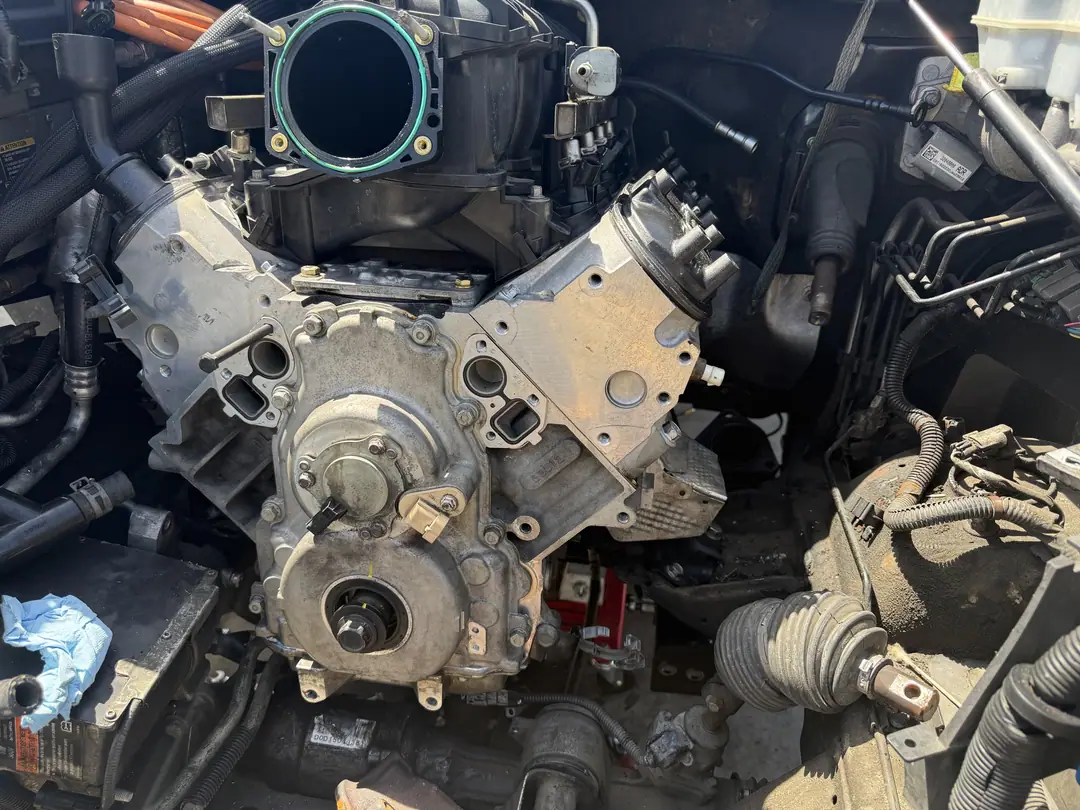 The LS V8 sitting in the engine bay of a GM truck before the intake goes on