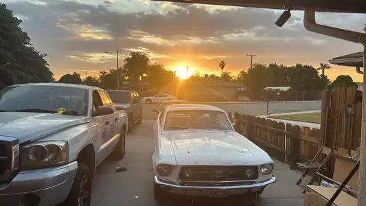 Mustang in the driveway as the sun sets