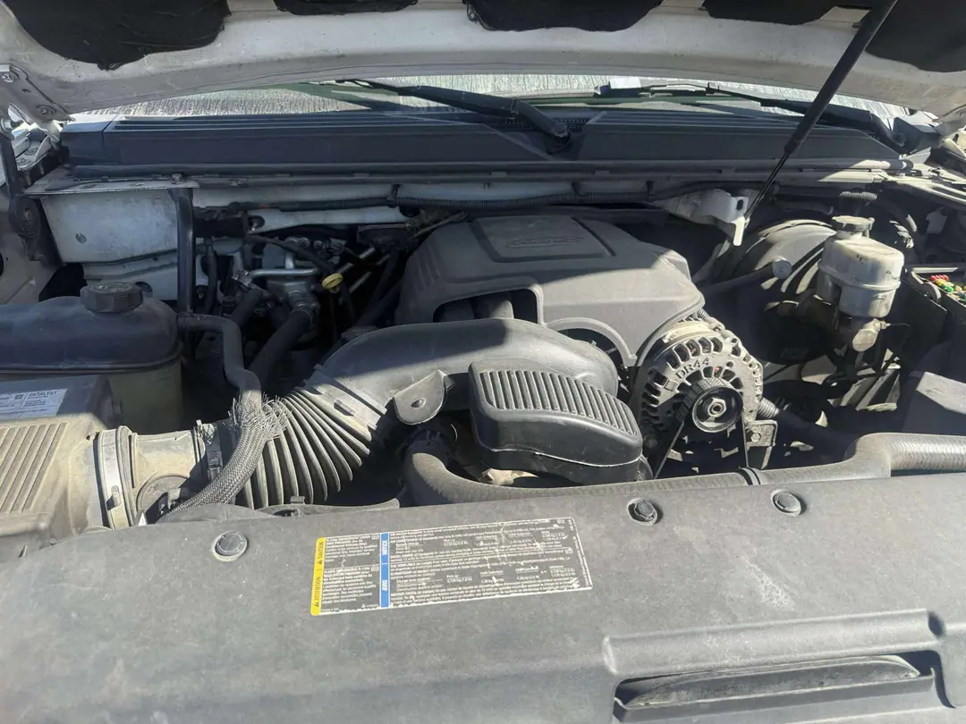 A GM V8 engine bay with the intake and air box in place before removal