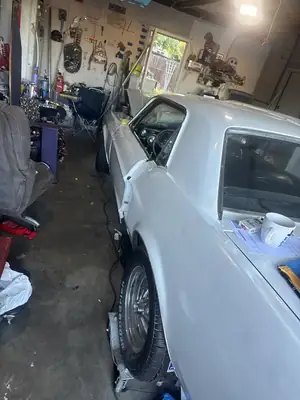 Mustang in the garage mid-wrap
