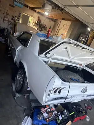 Wrapped Mustang with the trunk open in the garage
