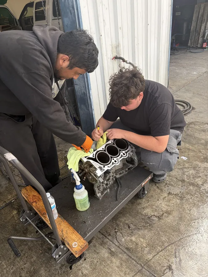 Technicians prepping an engine block