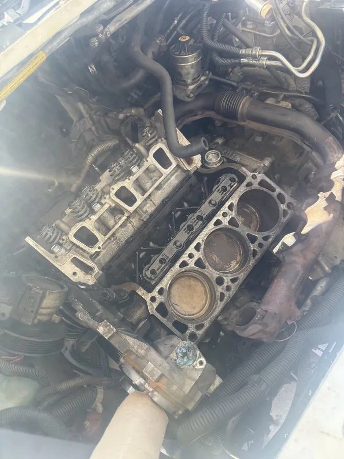 Engine teardown with the heads off and carboned cylinders exposed