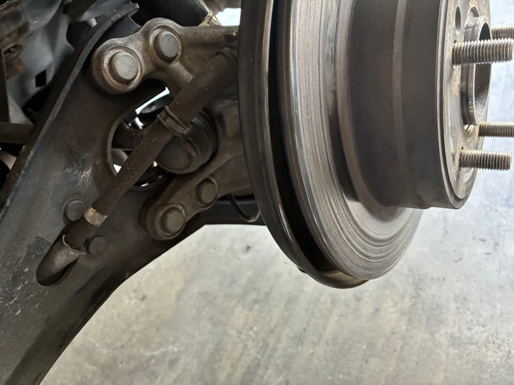 Brake rotor and hub exposed during a brake inspection at the San Jacinto shop