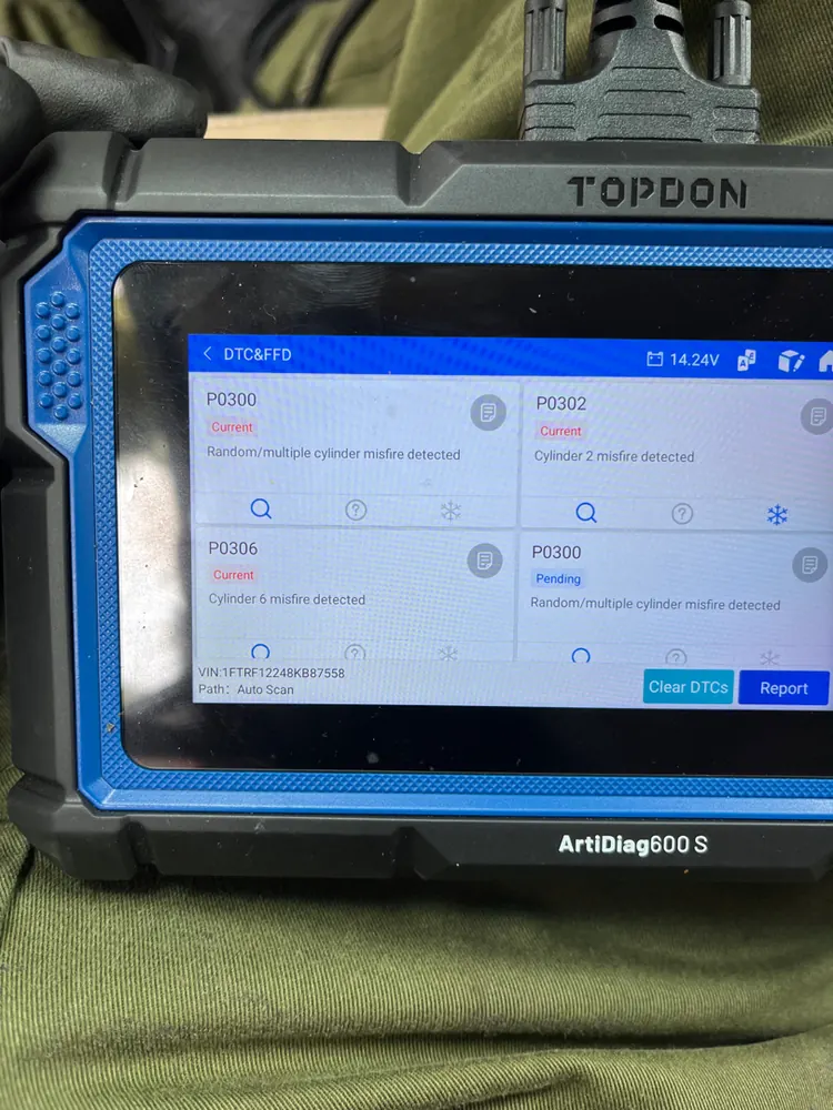 TOPDON scan tool connected and displaying multiple misfire codes during a check engine light diagnostic