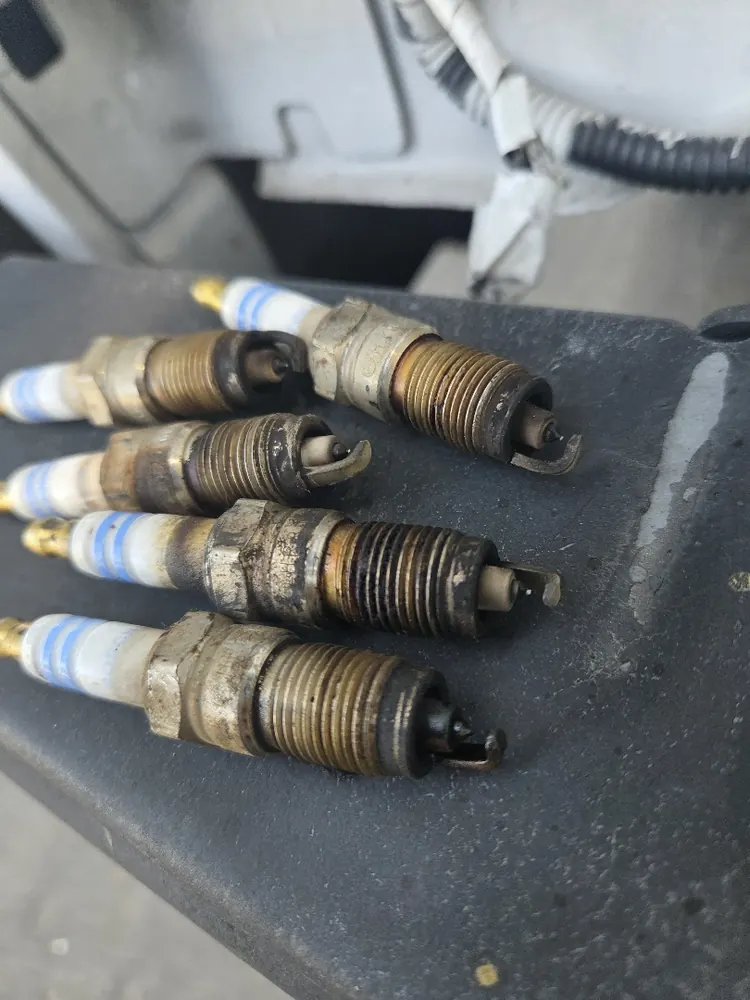 Set of badly worn spark plugs that were causing misfires and a check engine light