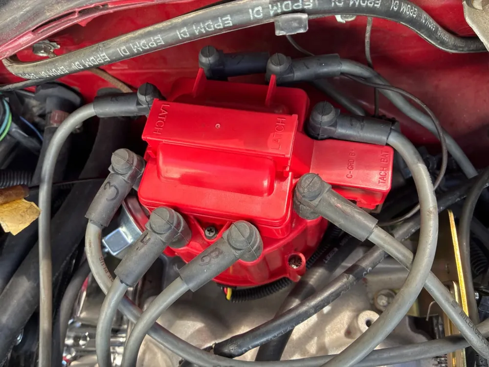 New red distributor cap and plug wires on a Camaro V8