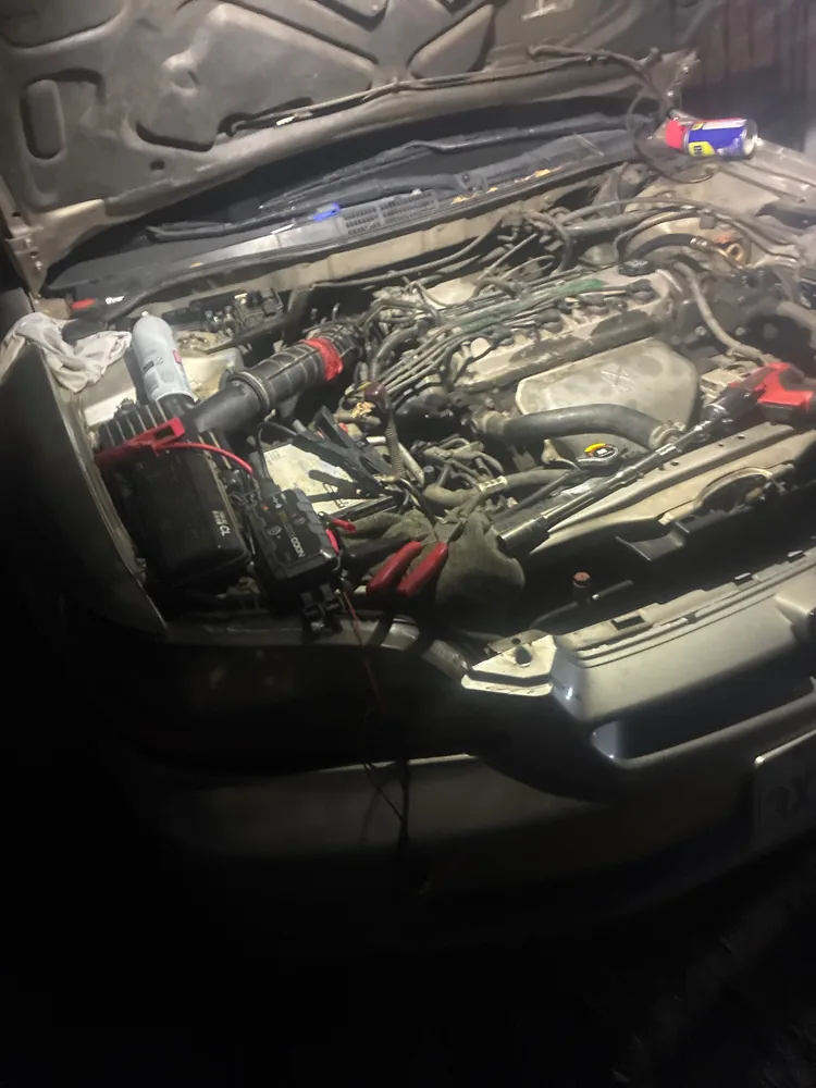 Front of the 1998 Honda Accord at night with the hood up and a work light on the engine