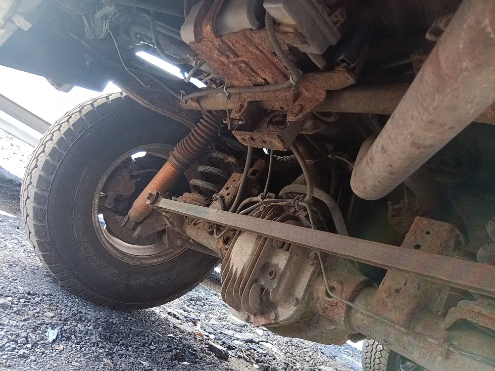 Rust on the axle, shocks and suspension bars under a 1998 Isuzu Rodeo