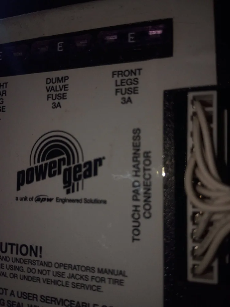 The label on a Power Gear leveling system box showing fuse labels and the touch pad harness connector