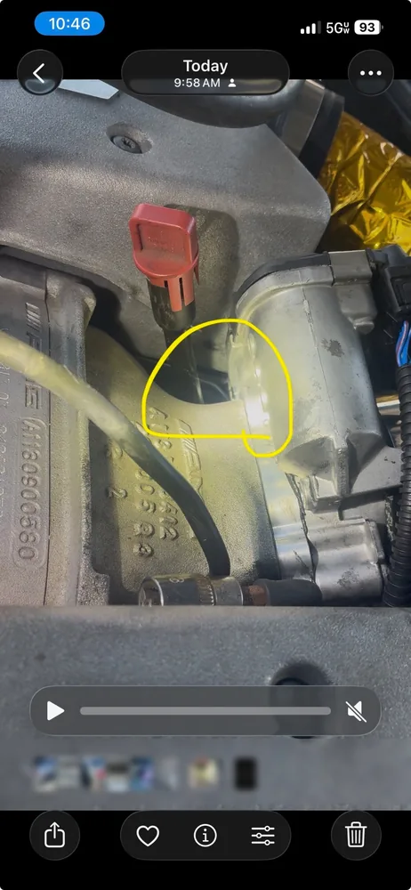 A frame from the tech's video with a yellow circle drawn around the throttle body joint on a Mercedes E55 AMG
