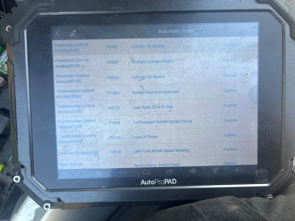 A scan tool screen listing misfire codes P0306, P0300 and P0303 with transmission and ABS codes below them