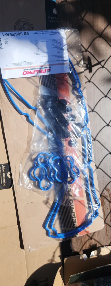 A new Fel-Pro valve cover gasket set in its package, laid on a cardboard box