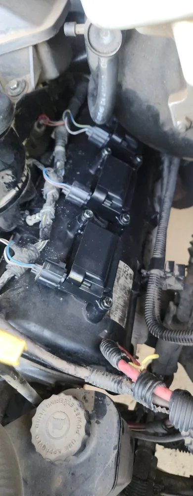 Top of the 2007 Dodge Ram engine with coil packs and wiring in place after the work
