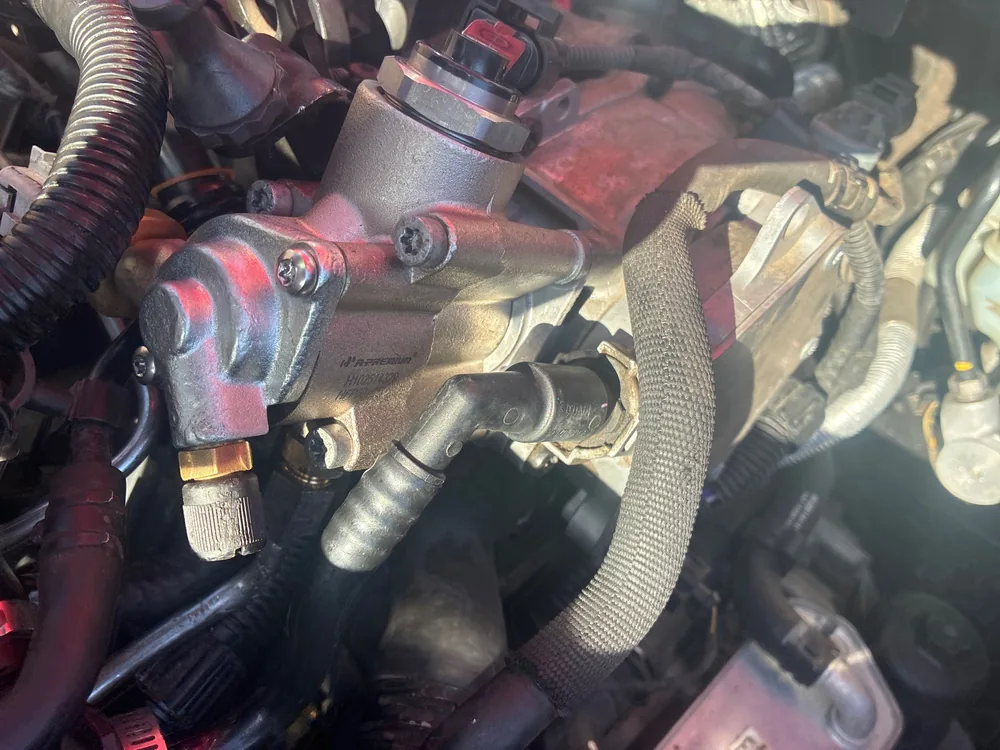 The fuel pump and fuel lines on top of the engine in a 2008 Audi TT