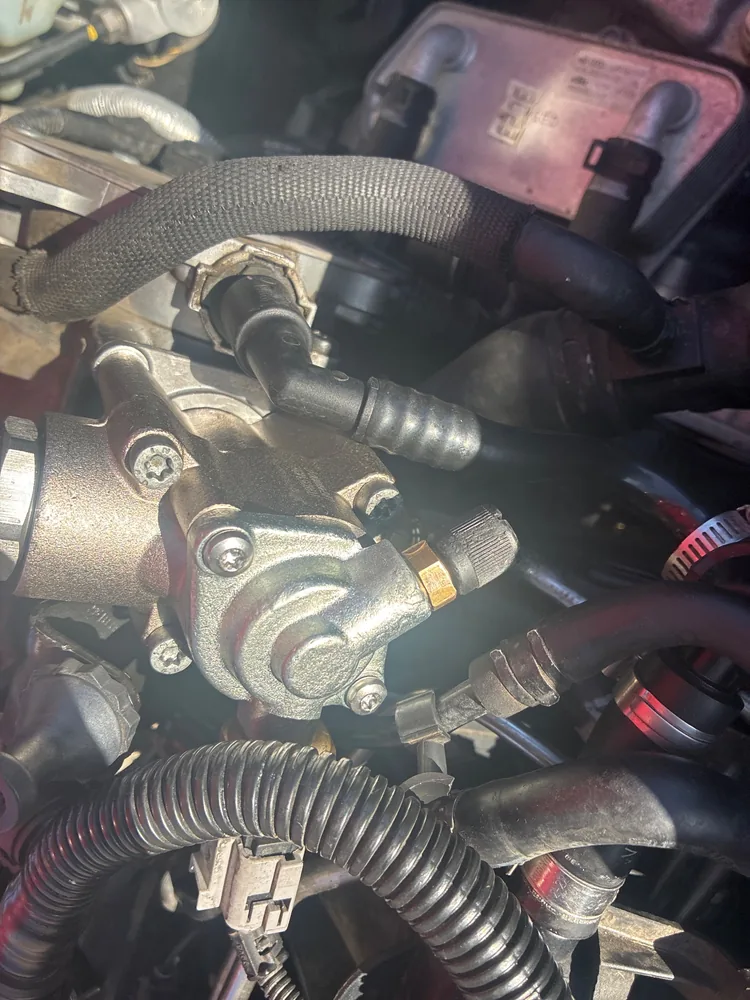 Close view of the fuel pump fittings and hoses on the 2008 Audi TT engine