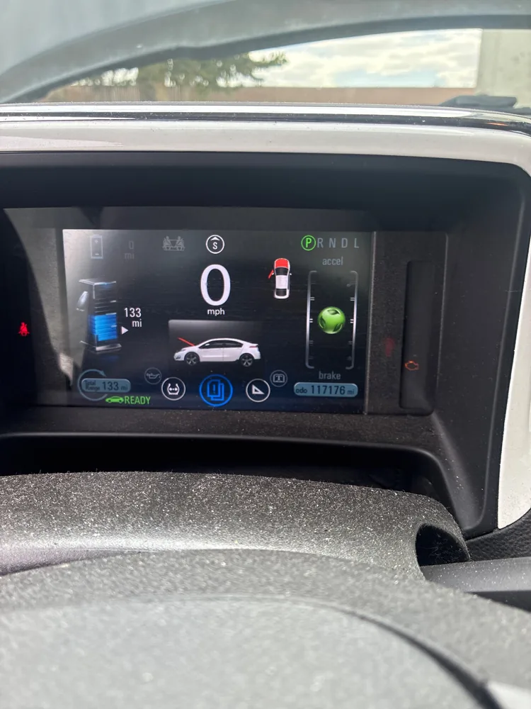 The digital dash of a 2013 Chevy Volt showing Ready, 0 mph and 117,176 miles