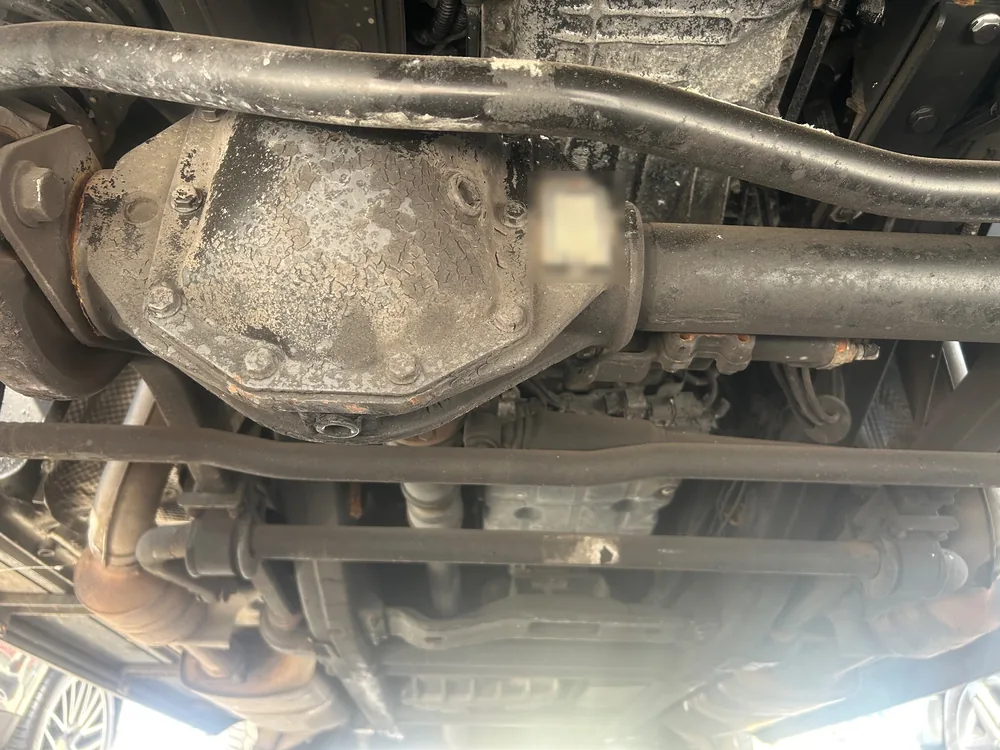 The underside of a 2015 Mercedes G550 showing the rear axle and driveline