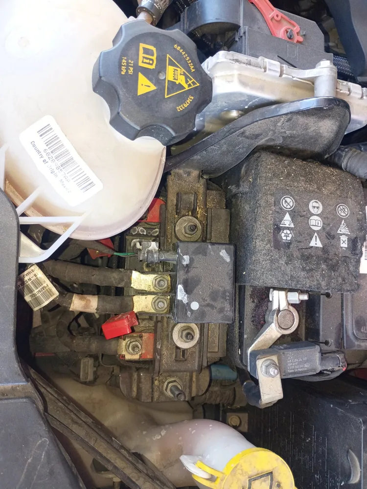 The battery, fuse block and coolant tank under the hood of a 2020 Jeep Compass