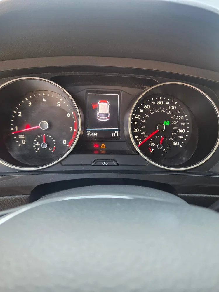 The instrument cluster of a 2020 Volkswagen Tiguan with a warning light lit