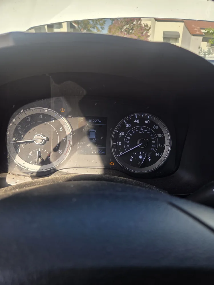 The instrument cluster of a 2022 Hyundai Venue with the check engine light lit
