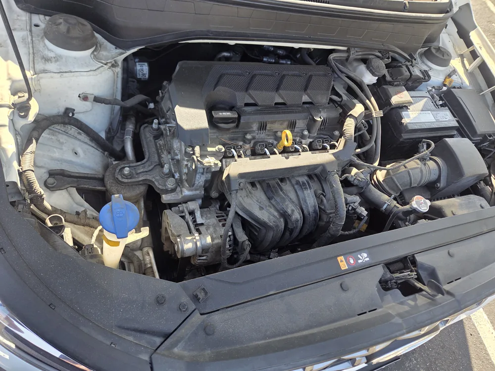 The four cylinder engine bay of a 2022 Hyundai Venue with the hood up