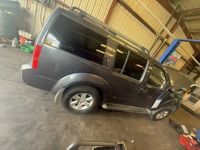 A gray Nissan Pathfinder parked inside the Supercanic shop in San Jacinto