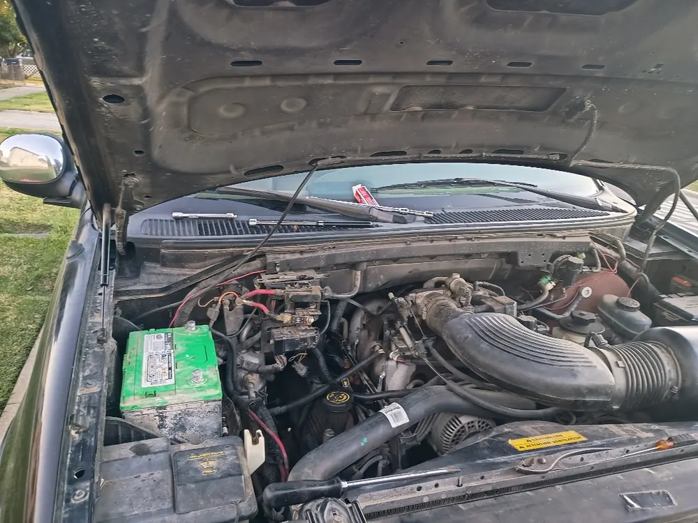 1997 Ford F-150 4.6 engine bay during spark plug thread repair in Beaumont CA