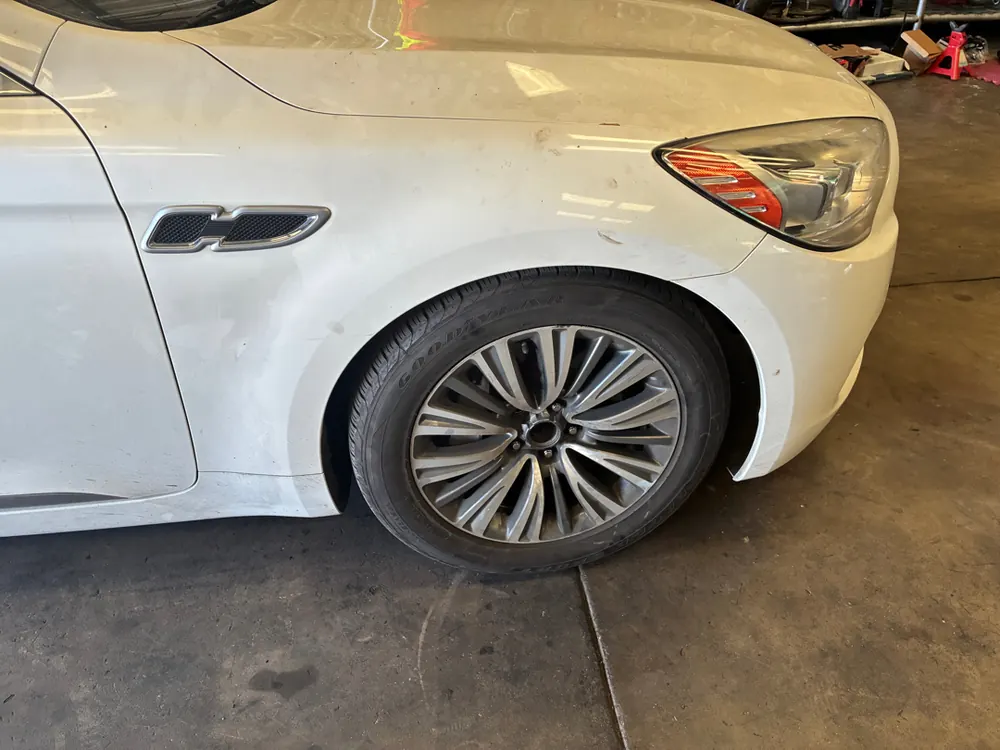 Wheel and fender inspection on a Kia K900 from Corona CA