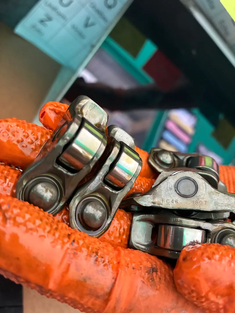 Worn rocker arms removed from an engine during a build
