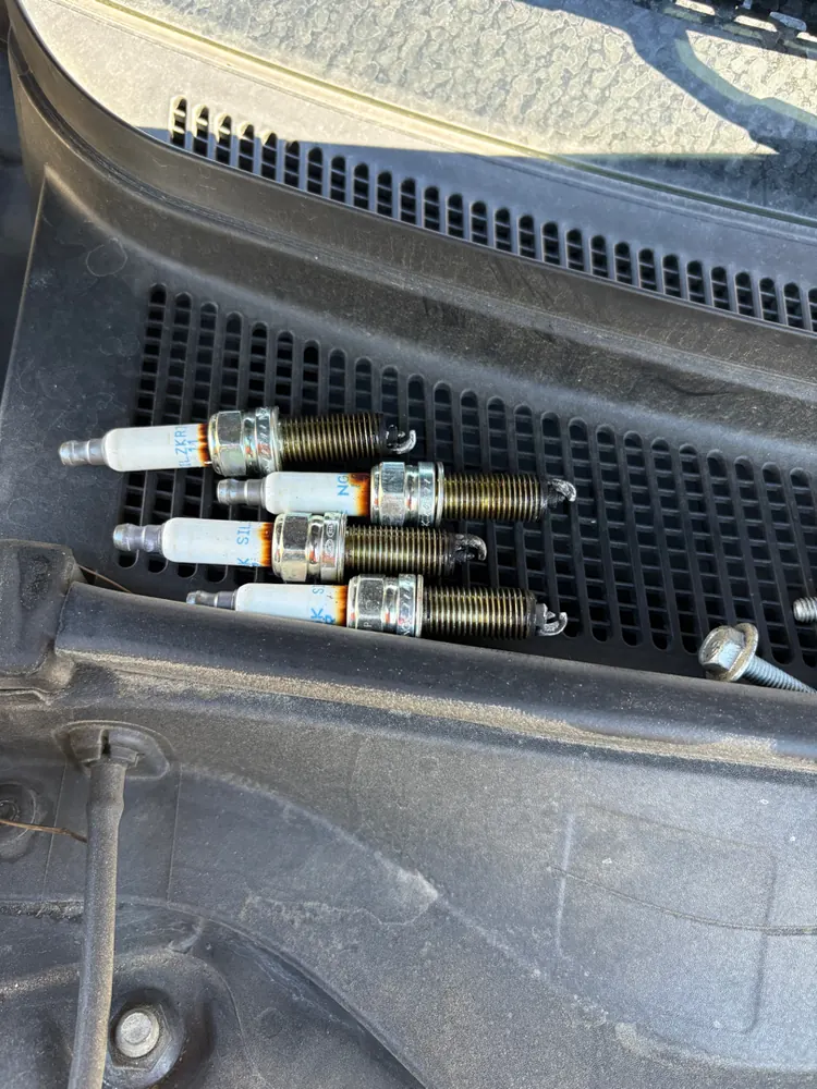 Old spark plugs pulled during a mobile tune-up at a Hemet CA home