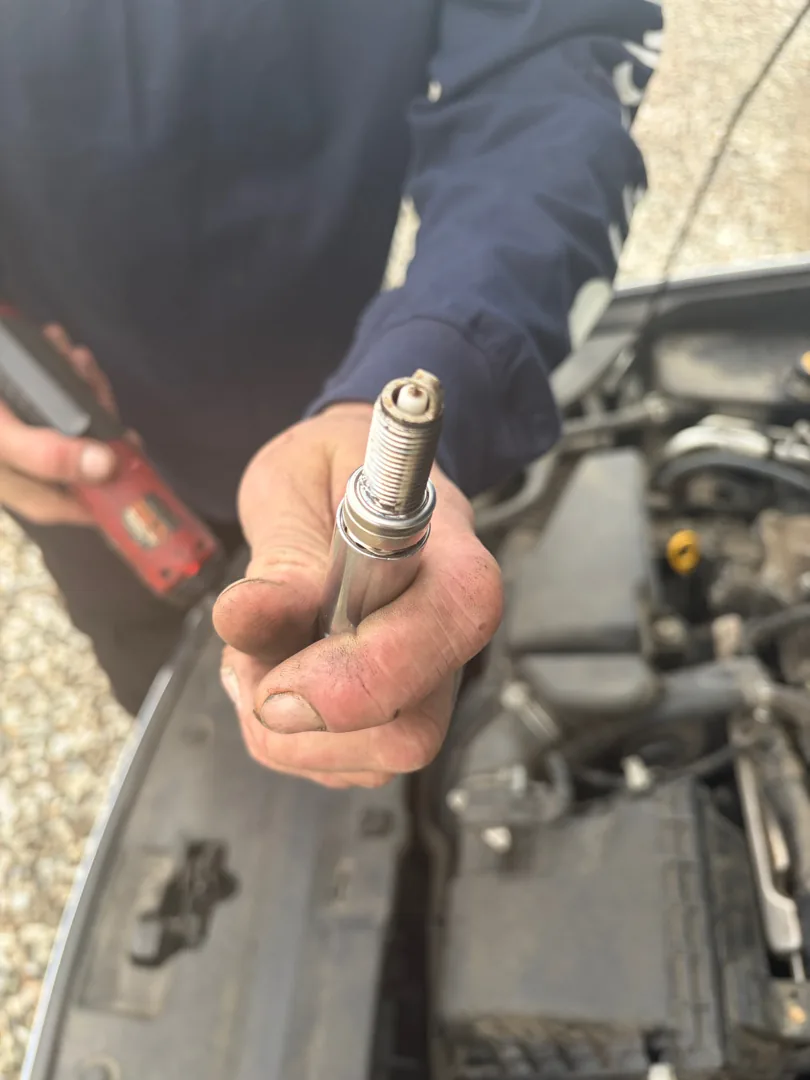 Technician pulling a spark plug at a Moreno Valley CA house call