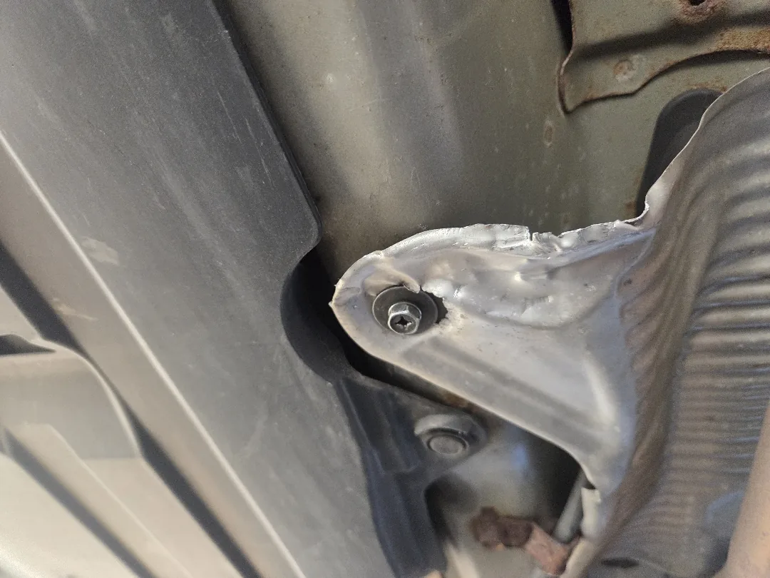 Loose exhaust heat shield found during an underbody inspection