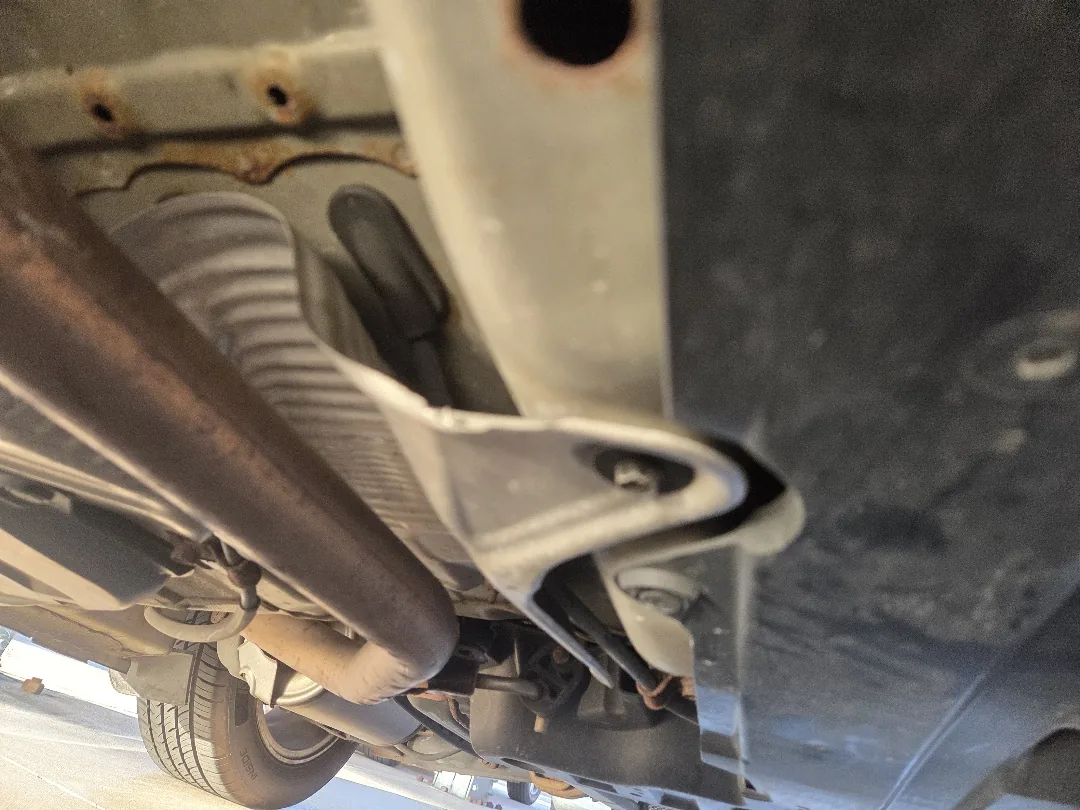 Underbody view of a truck during inspection on the lift