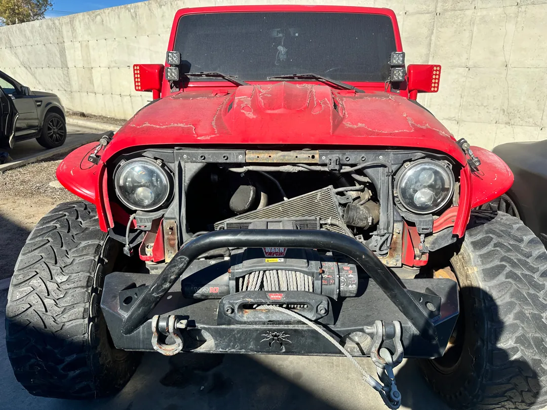 Jeep Wrangler with the grille removed and winch exposed during a San Jacinto CA repair