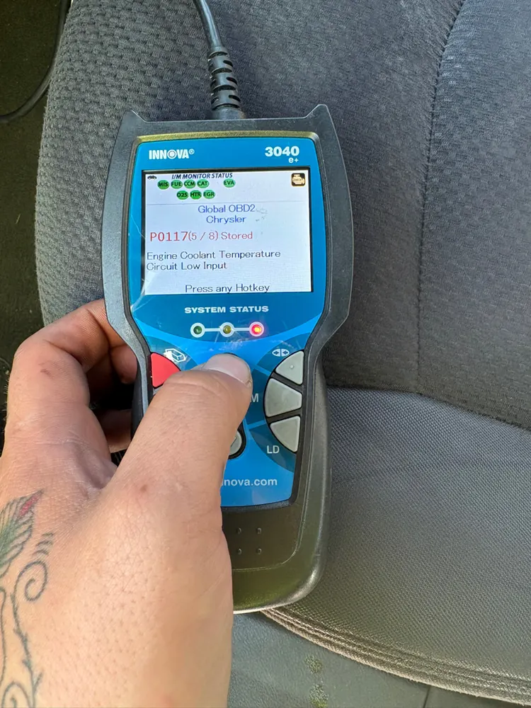 Scan tool showing code P0117 engine coolant temperature sensor circuit low