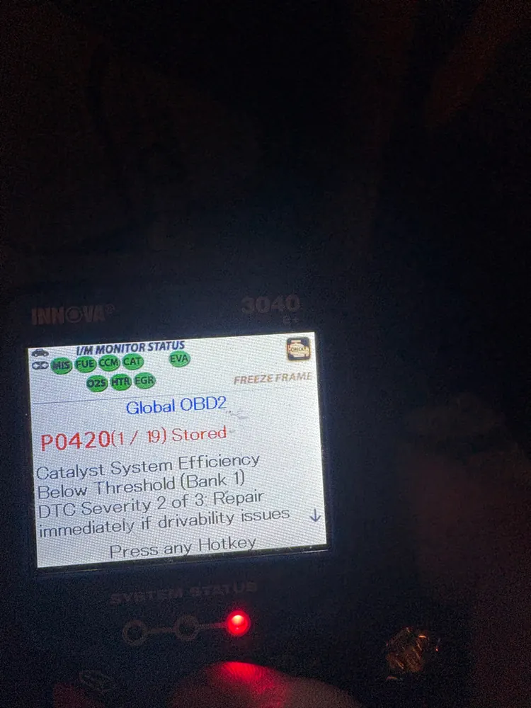 Scan tool with freeze frame showing code P0420 catalyst system efficiency below threshold