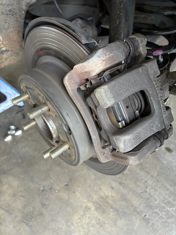 Rear caliper and hub during a brake diagnostic in San Jacinto CA