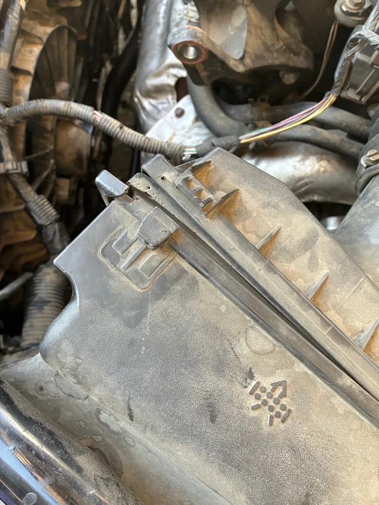 Old leaking radiator removed from a Chevy Impala during radiator replacement in Hemet CA