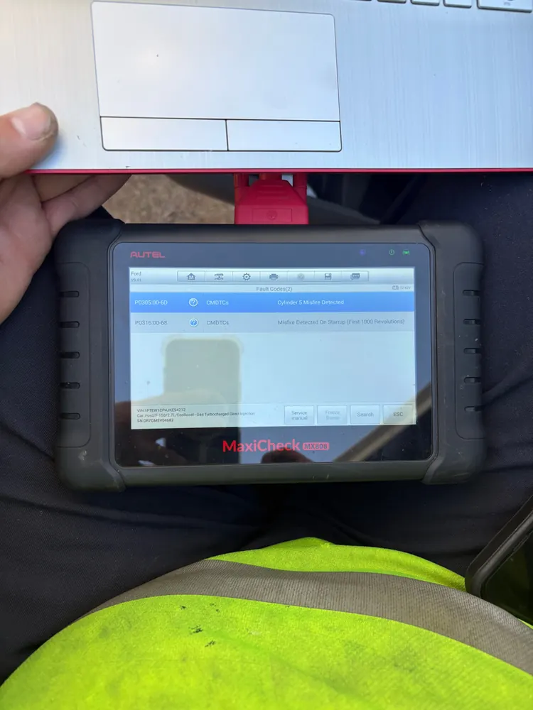 Supercanic technician running a full-system scan on a diagnostic tablet during a mobile call in Hemet CA