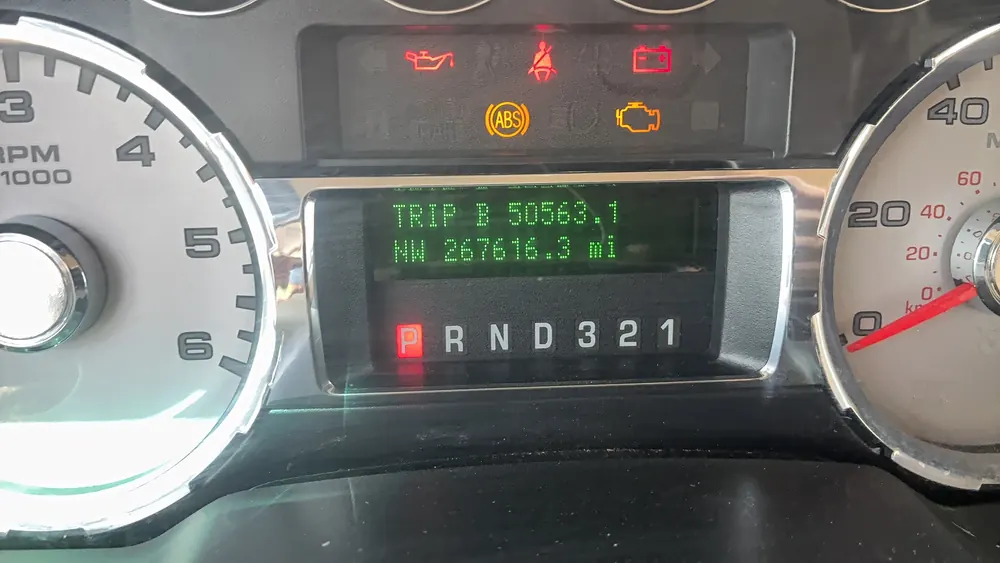 Ford F-250 odometer showing 267,000 miles - diesel trucks we keep alive