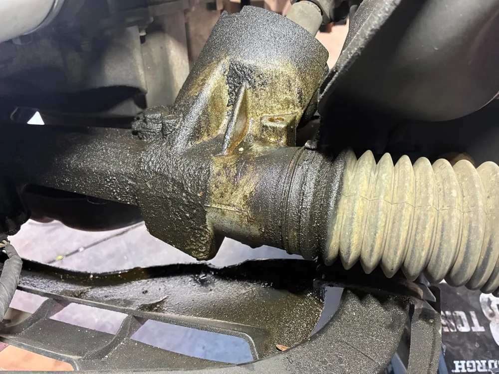 Leaking steering rack boot found during a suspension diagnostic on a Ford Mustang